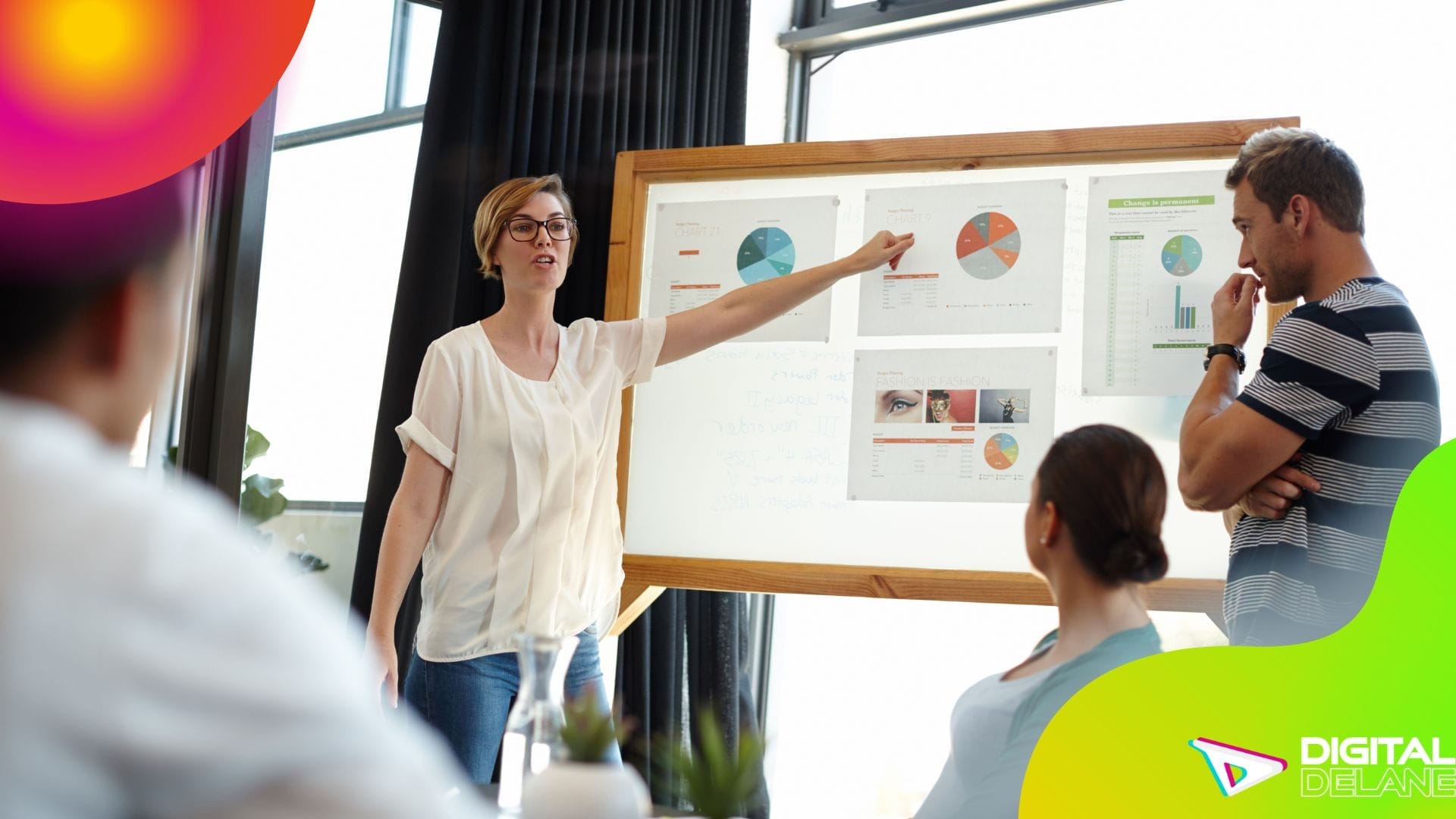 A diverse group of individuals gathered around a whiteboard, engaged in discussion and collaboration.