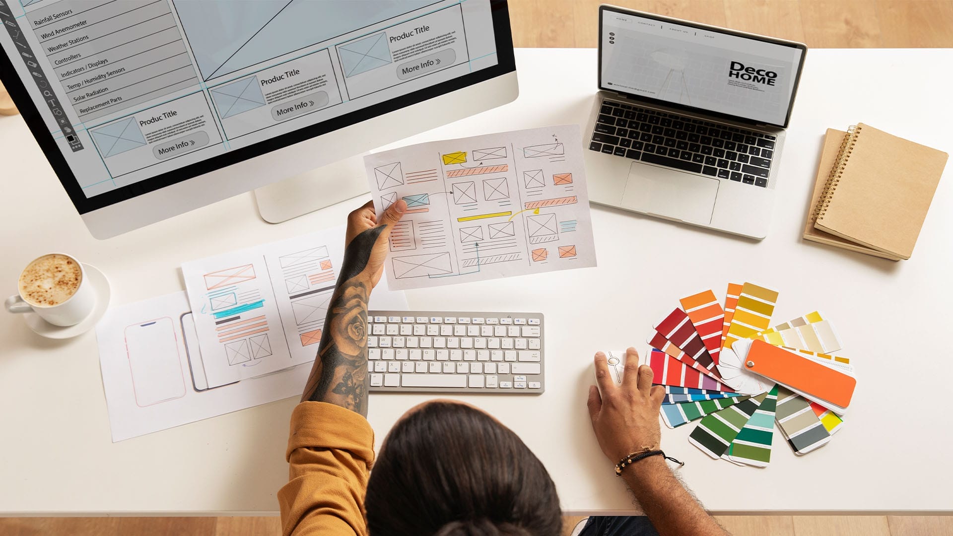A person seated at a desk, working on a computer with a monitor, illustrating a typical office environment.