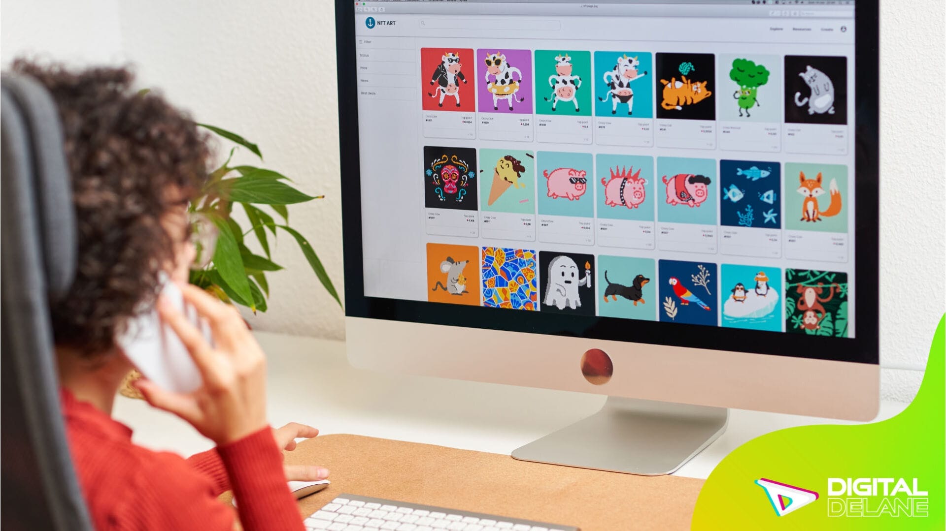 A woman sits at a desk, focused on a computer screen displaying a colorful cartoon.