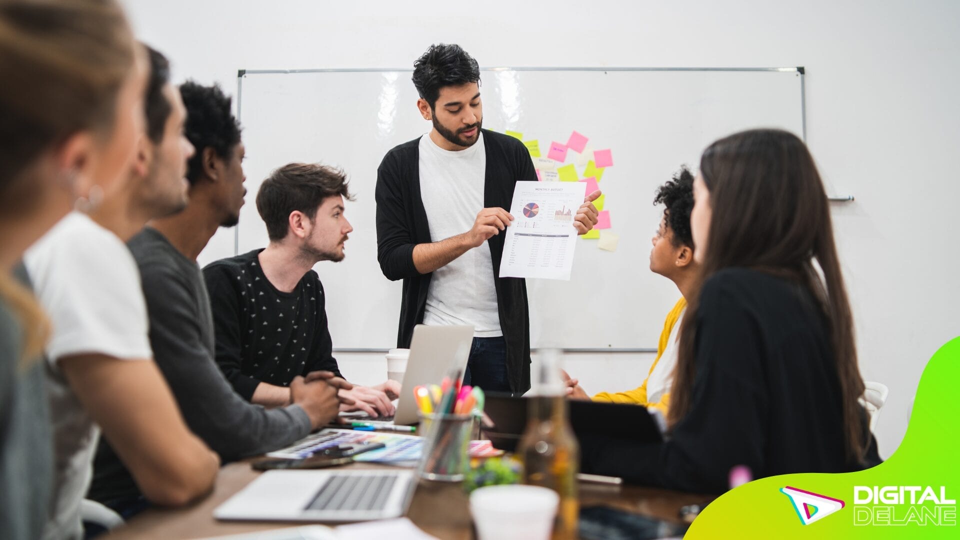 A man presents to a group in a meeting room, discussing strategies for local lead generation and community engagement.