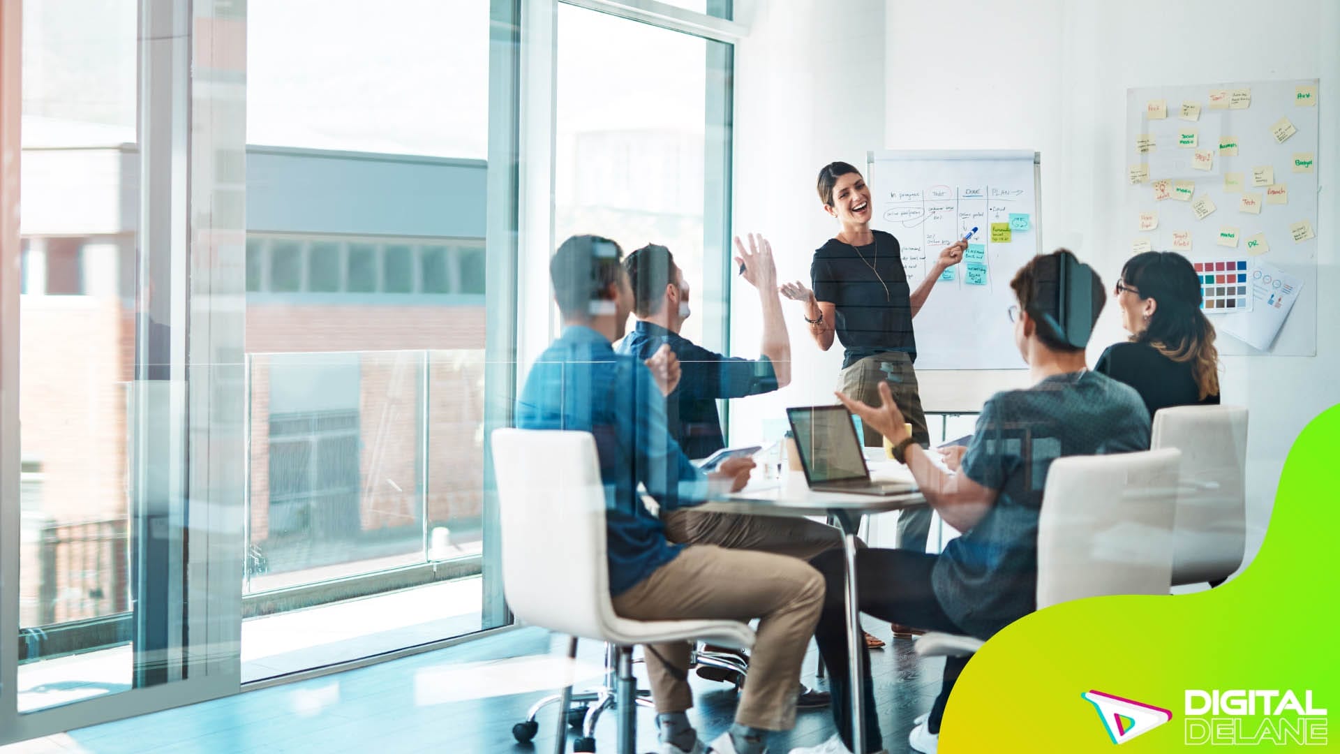 A diverse group of individuals engaged in discussion around a conference table in a professional meeting room.