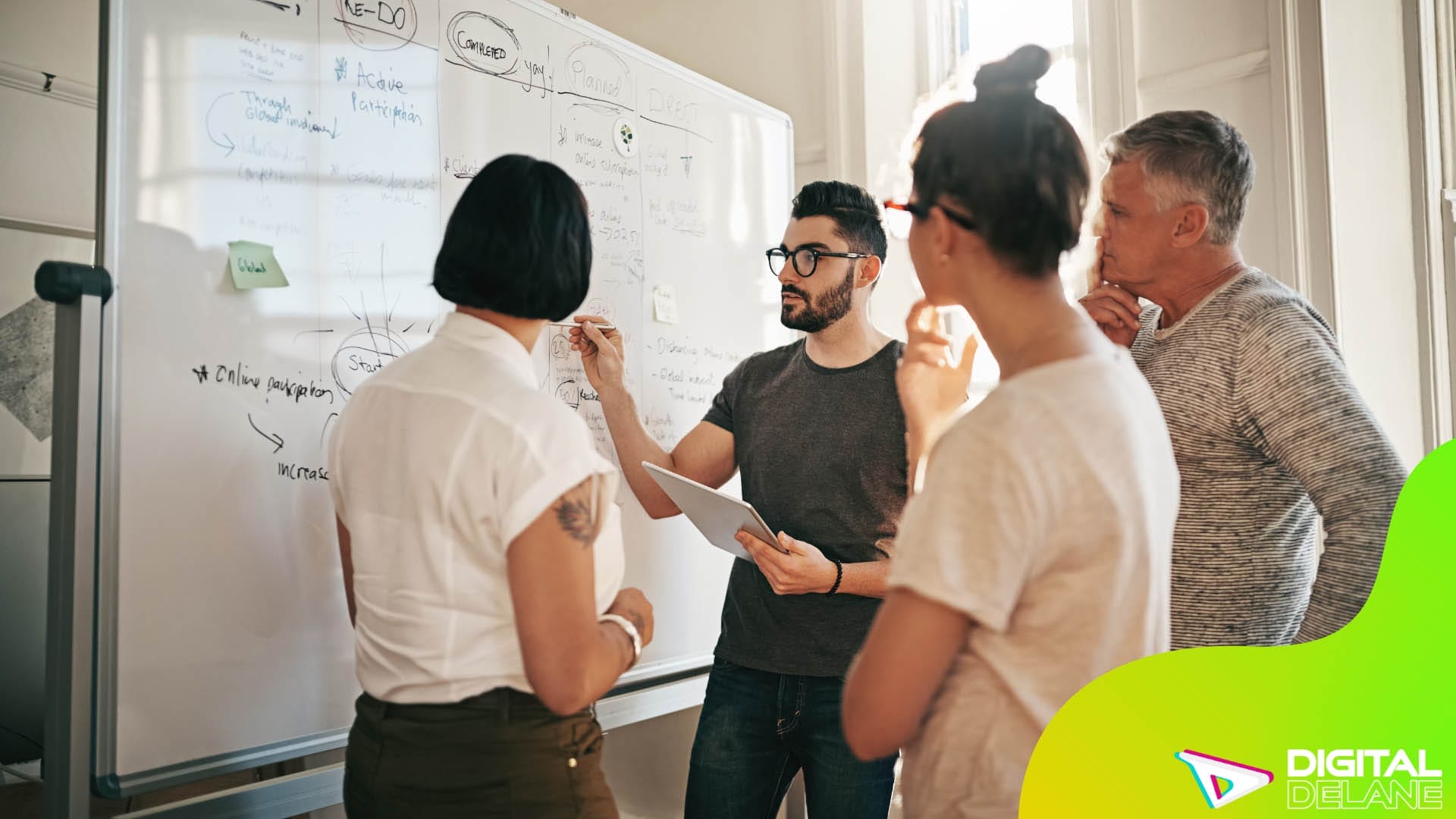 A diverse group of individuals collaborating around a whiteboard, discussing strategies for enhancing personalization.